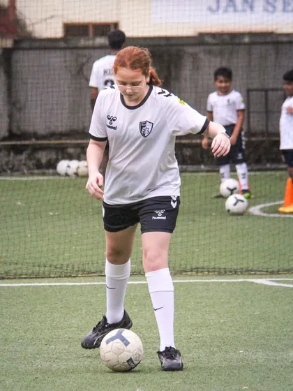 Concentration is key. This player from our U14 girls' batch is focused on a ball control drill, showcasing the discipline and dedication we encourage. Our training helps build both technical skills and mental strength.