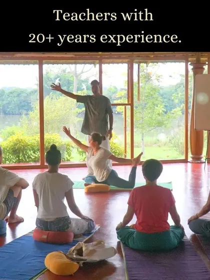 Our teachers bring over 20 years of experience to each class. Here, a student receives personalized guidance on asana alignment, ensuring a safe and effective practice.