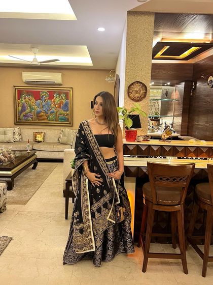 A full view of my black and gold lehenga saree. It's a statement piece that's perfect for weddings or festive celebrations.
