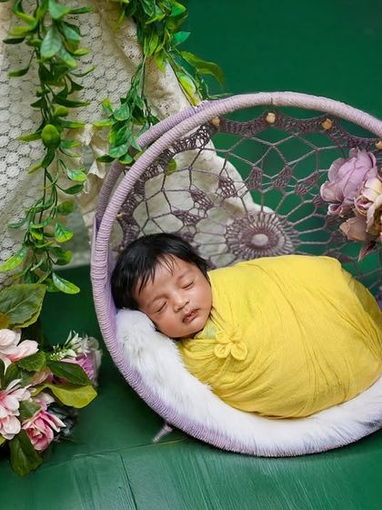 A wider view of the dreamcatcher swing setup, showing the lace curtain and floral arrangements.