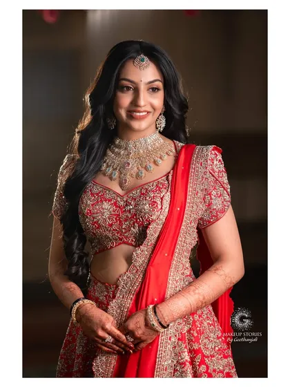 Likitha looking absolutely radiant and happy at her reception. The soft waves in her hair and the glowing makeup create a look that is both glamorous and effortlessly chic.