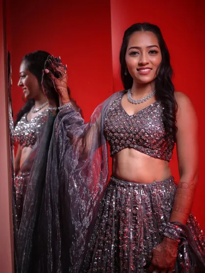 A beautiful shot of the sanget bride, her makeup looking flawless against the red background.