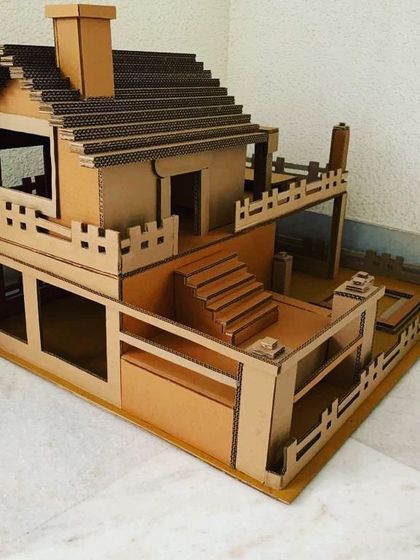 This detailed, multi-level dollhouse is another example of my interactive builds. Made from corrugated cardboard, it features stairs, a balcony, and a chimney, providing a sturdy structure for kids to decorate and play with.