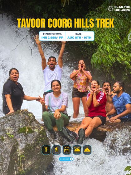 A group of friends enjoying a refreshing dip in a waterfall during the Tavoor Coorg Hills trek.