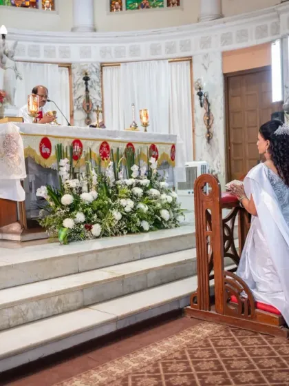 Capturing the sanctity of the ceremony. This shot shows the couple kneeling at the altar during their Silver Anniversary mass, a testament to their enduring faith and love.