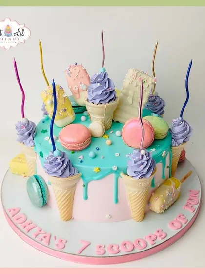 "7 scoops of fun" for Adhya's birthday! This ice cream-themed cake is a delightful explosion of color, topped with mini cones, macarons, and cakesicles.