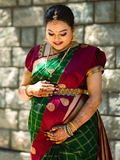 Kruthika looking down at her baby bump. This is such a special time, and I focus on creating a makeup look that makes moms-to-be feel comfortable and beautiful.