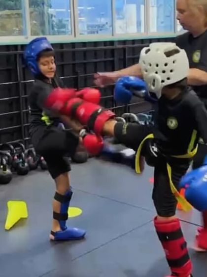 Always learning and growing. A coach provides feedback during a sparring drill, ensuring our students are developing good habits.