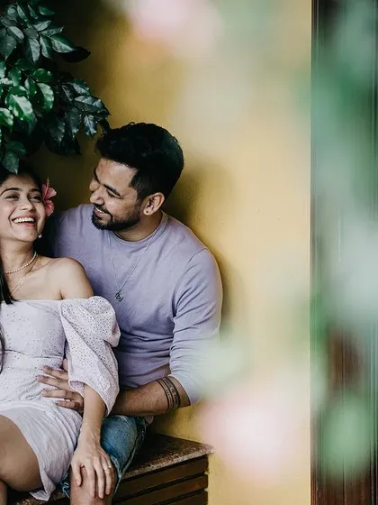 A duplicate of image 48, a sweet, candid moment on a bench, with the couple sharing a laugh.