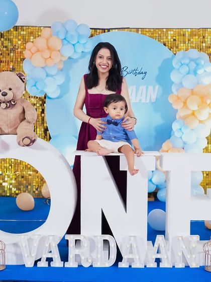 A charming 'Little Man' themed first birthday party, with a sophisticated black and white color scheme, mustache props, and a stylish backdrop, perfect for a dapper celebration.