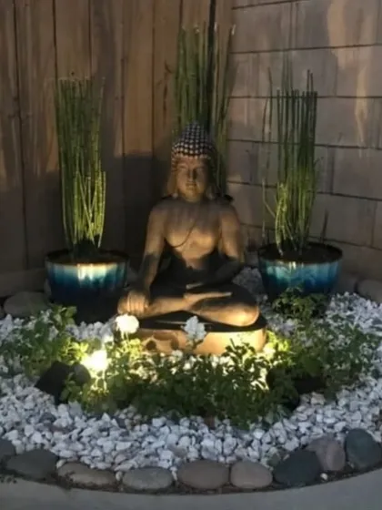 A peaceful Buddha-themed garden I designed for a client's corner space. The use of uplighting, white pebbles, and tall, slender plants creates a serene atmosphere, especially at night.