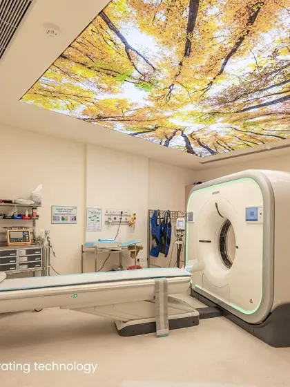 A key aspect of patient-centered design is integrating technology in a way that supports, rather than intimidates. This diagnostic room combines advanced imaging equipment with a calming, nature-inspired ceiling, demonstrating our commitment to enhancing the patient's emotional and cognitive health.