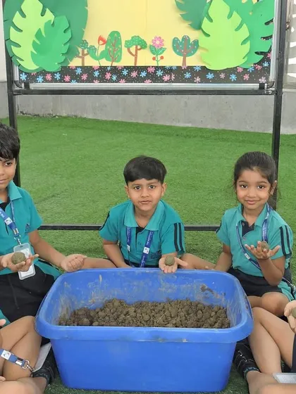 Getting their hands dirty, students learn to make seed bombs. We believe in practical, hands-on learning to connect children with nature.