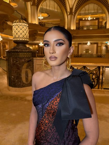 A close-up on the makeup, showing the sharp liner and perfectly blended contour that complements the artistic vibe of the look.