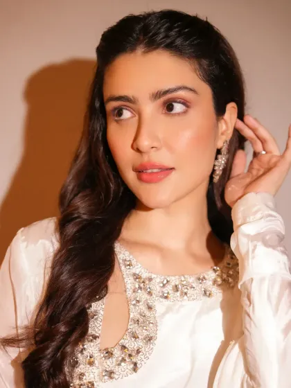 A candid, happy moment. The soft lighting highlights the radiant skin and subtle shimmer on the eyes, perfect for a daytime event or pre-wedding shoot.