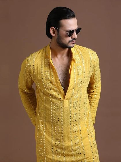 A modern take on the Haldi kurta, featuring vertical sequin embroidery. This piece is for the man who appreciates a sharp, contemporary aesthetic.