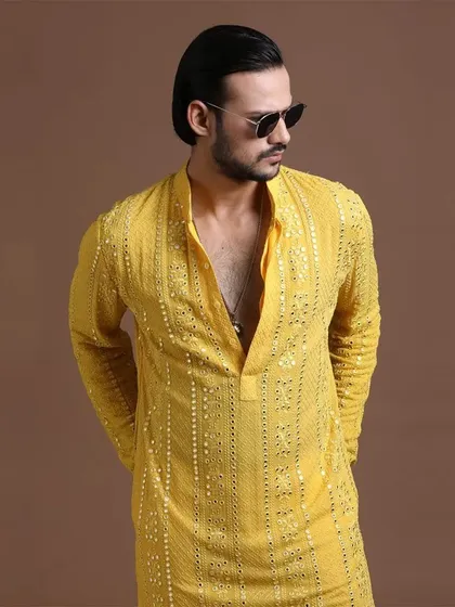 A modern take on the Haldi kurta, featuring vertical sequin embroidery. This piece is for the man who appreciates a sharp, contemporary aesthetic.