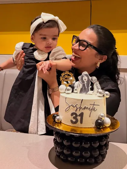 A playful shot from my birthday, where Gauri is reaching for the cake. It's a cute, authentic moment that captures the reality of celebrating anything with a toddler.