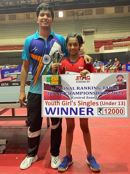 Divyanshi with her winner's trophy and check.