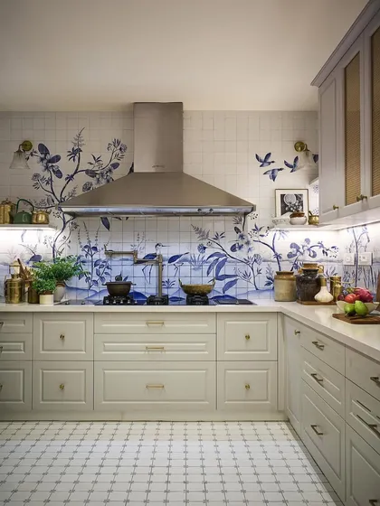 For me, a kitchen can be a canvas. In this space, the walls are adorned with hand-painted ceramic tiles that tell a story, turning the entire room into a piece of art. It’s a testament to how bespoke details can create a truly personal and unforgettable sanctuary.