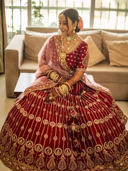Another beautiful shot of the bride, seated and looking away from the camera. The makeup is flawless from every angle, highlighting her best features.