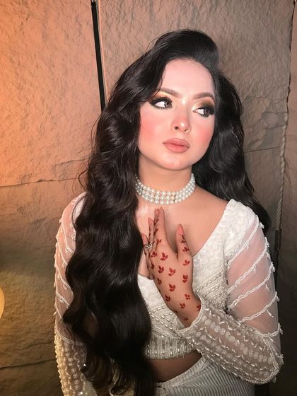 A graceful portrait showcasing the pearl choker and the soft, diffused makeup that enhances the model's features without overpowering them.