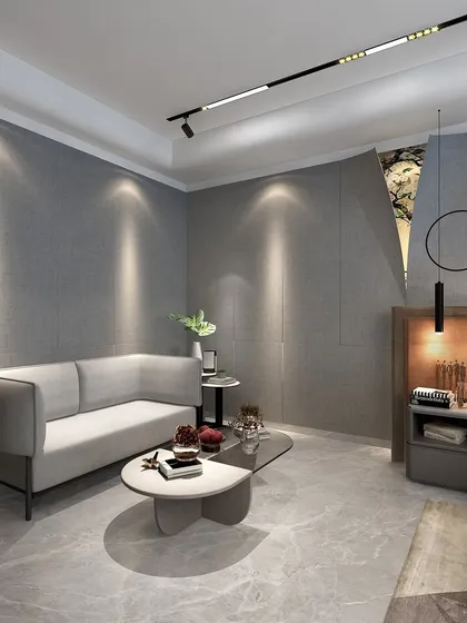 A seating area within the boy's room, featuring a simple gray sofa and a modern coffee table. The textured wall has a unique cutout revealing a glimpse of nature-inspired art.