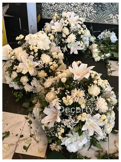 Bouquets of fresh white flowers being prepared for a corporate launch event. I use high-quality florals to add a touch of class and sophistication to any occasion.