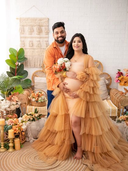 A beautiful portrait of the couple looking towards the camera. Their happy smiles and the stunning visual of her tiered gown make this a perfect keepsake.
