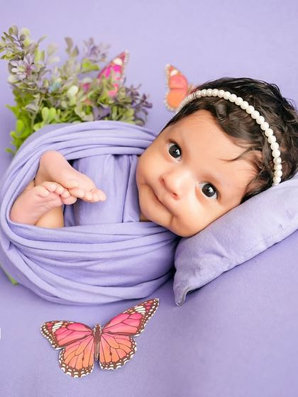 An awake and curious newborn looks directly at the camera, her bright eyes telling a story. I love capturing these moments of quiet alertness just as much as the sleepy ones.