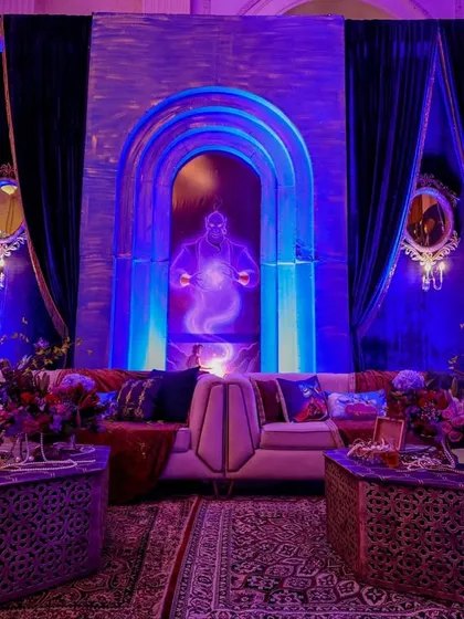 A view of the Genie-themed lounge, showing the comfortable sofas, patterned rugs, and ornate side tables.
