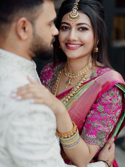 A close-up candid moment between the bride and groom. The bride's makeup looks flawless and natural even up close.