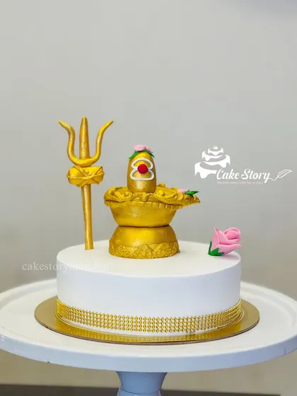 A divine cake for Mahashivratri. It features a golden, edible Shivling and Trishul. Please note, these sacred elements are for decoration and are removed before cutting the cake.