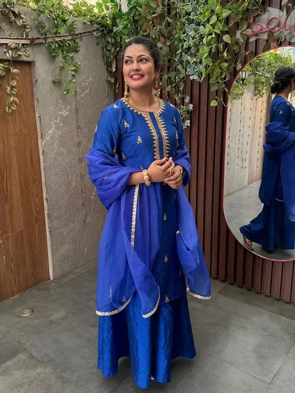 Another full-length view of the vibrant blue concert outfit.