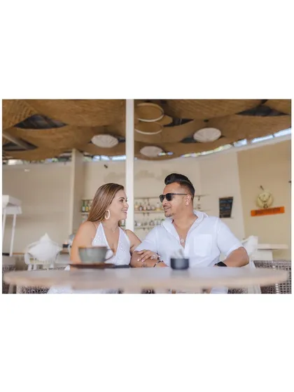 A quiet moment over coffee at a beach cafe. The simple composition and their relaxed expressions make for a beautiful and natural portrait.