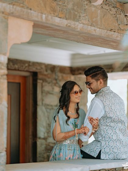 A sweet, candid moment between a young couple, their sunglasses adding a cool, relaxed vibe to the portrait.