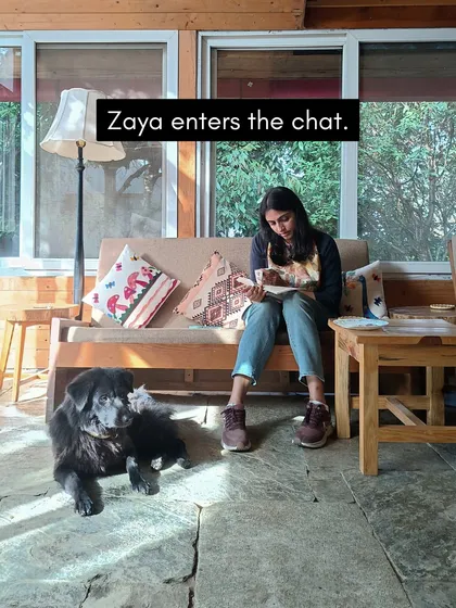 Our furry resident Zaya often joins the reading sessions, adding to the cozy, homely vibe of the retreat. Here, a participant enjoys a book with a four-legged friend.