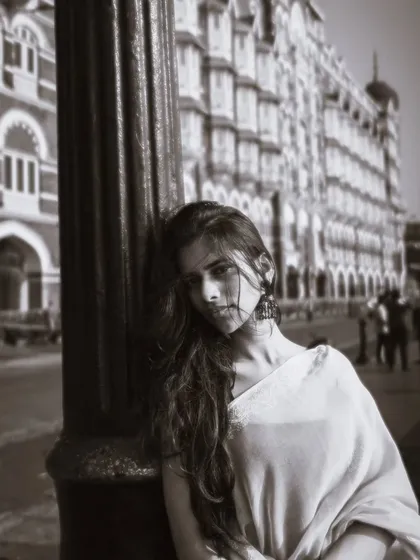 A classic black and white portrait in front of the Taj Mahal Palace Hotel, giving it a timeless, old-world charm.