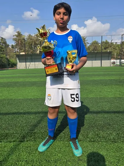 This U14 player holds both a team trophy and an individual award.
