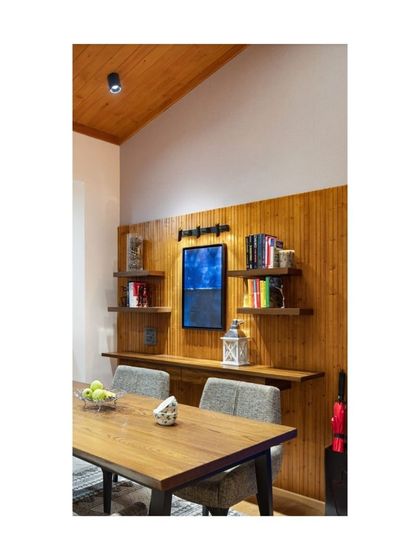 Crafted from pine wood, these shelves in our Valley of Dreams project evoke a warm, cozy hill station vibe. Paired with wood paneling, they create a cohesive and inviting atmosphere in the dining area.