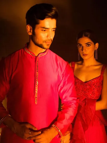 A classic portrait of a couple ready for a festive occasion. The makeup is refined and photogenic, designed to look great in the warm, dramatic lighting of an evening event.