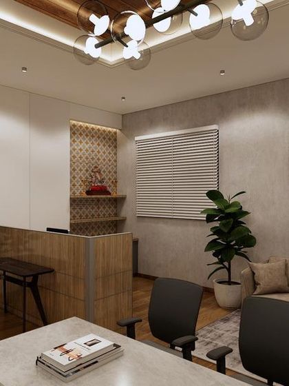The reception and waiting area for the Sankalp office features a textured concrete wall, comfortable seating, and a small pooja niche, blending modern design with traditional elements.