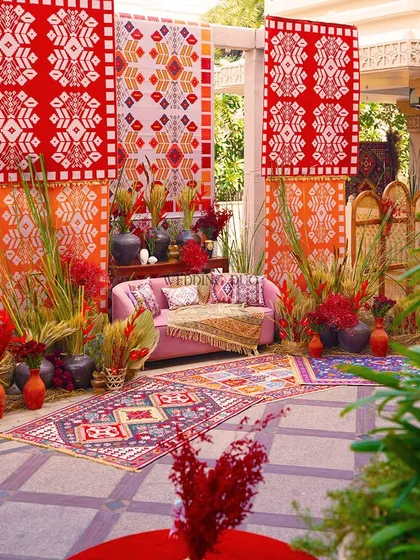 We elevated this Bhaat ceremony with a vibrant mix of patterns, textures, and colors. Inspired by African tribal art, the setup used bold red and orange textiles, rustic pottery, and dried grasses for a culturally rich and visually stunning look.