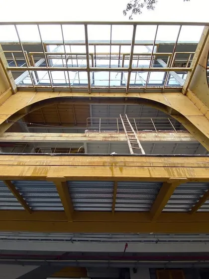 A view of the building's large arched entrance during restructuring. This powerful form is retained and enhanced, serving as the main gateway into the newly imagined commercial space.