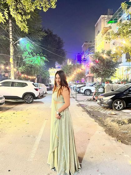 A candid, happy moment in the green lehenga. This captures the festive spirit and makes the content feel joyful.