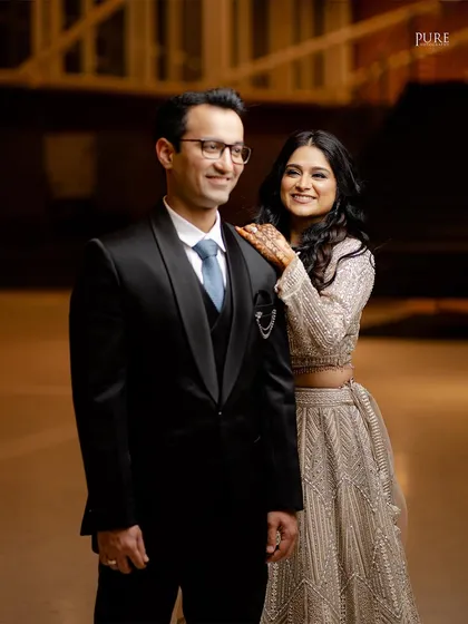 A classic, elegant portrait from a cocktail party. The couple's formal wear and confident poses give this shot a timeless feel.