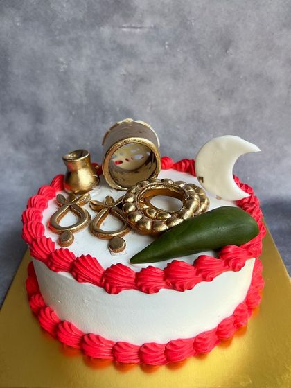 This Karwa Chauth cake is adorned with edible symbols of the festival, including a sieve, a 'karwa' pot, and the moon.