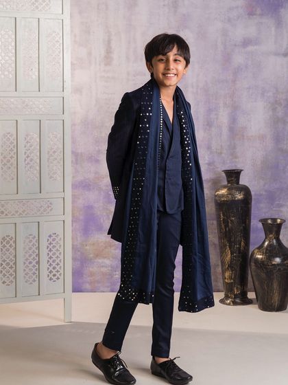 Another angle of the navy blue embellished Indo-western set. The long jacket, or sherwani style coat, is layered over a simple kurta, making it perfect for a winter wedding.