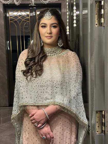The full view of this elegant engagement look. The makeup is soft and glowing, perfectly complementing her beautiful Tarun Tahiliani outfit and creating a look of pure sophistication.