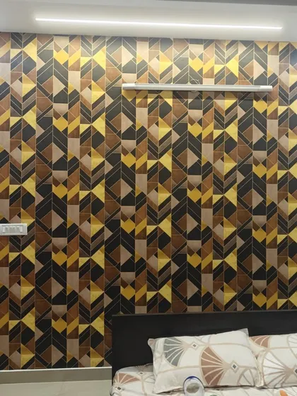 Geometric patterns are perfect for creating a modern and energetic vibe. Here, I installed a bold, 3D-effect geometric wallpaper as a bedroom accent wall. The interplay of black, brown, and yellow tones adds depth and character, complementing the contemporary furniture.